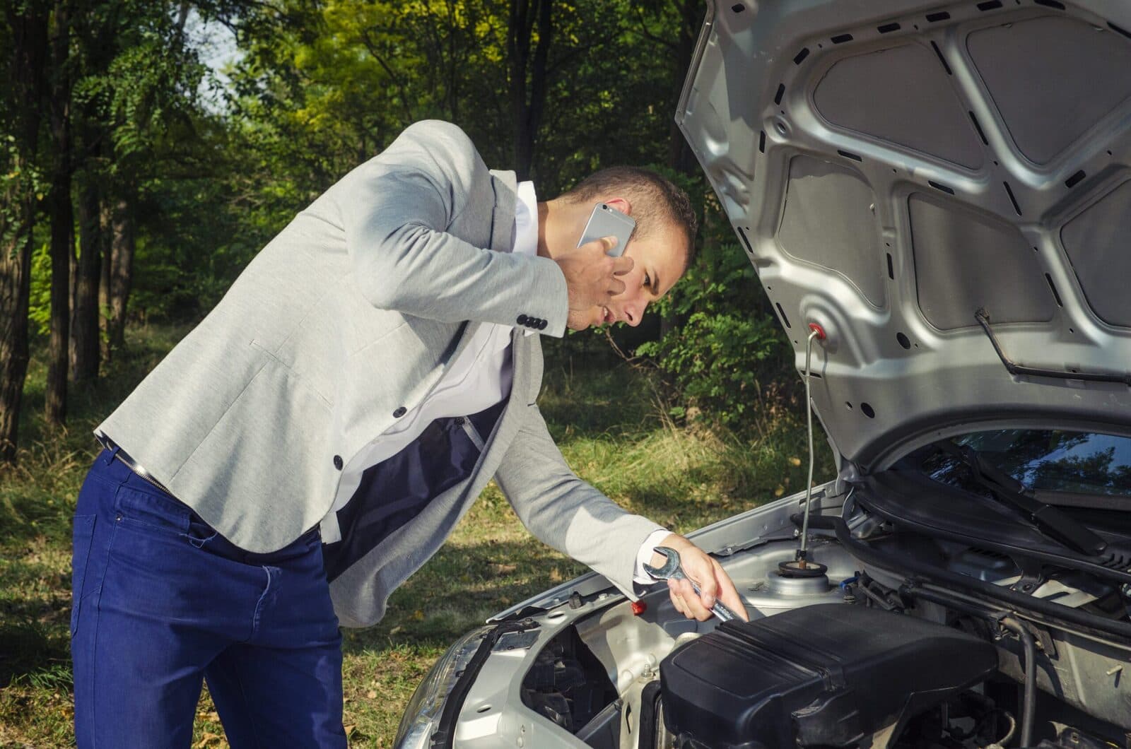 man trying to fix vehicle
