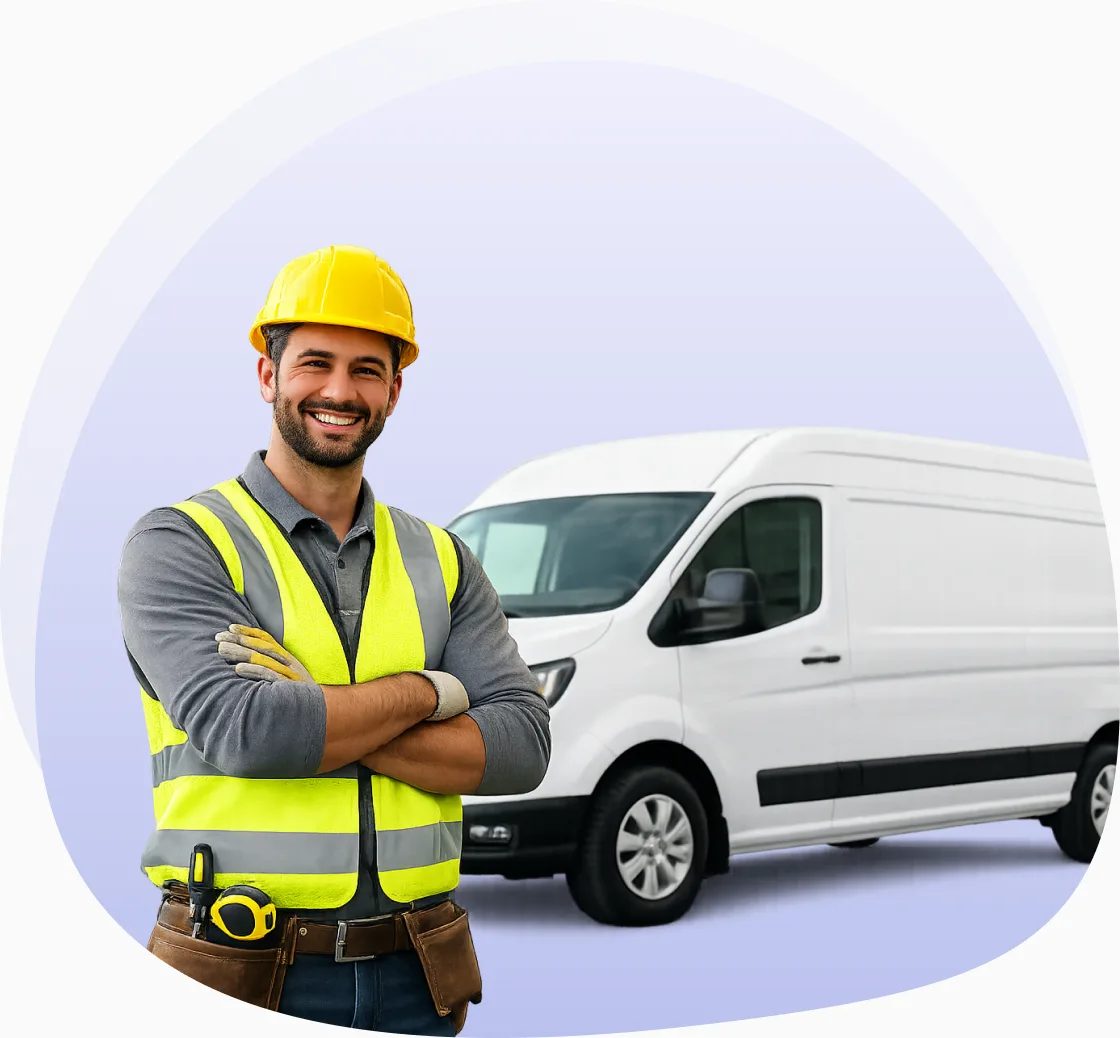 A tradesperson in a hi-vis vest standing beside a white cargo van